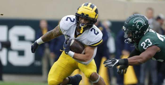 Michigan Wolverines running back Blake Corum on a rushing attempt during a college football game against Michigan State.